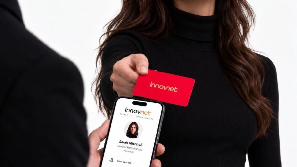 Red Innovnet metal card held next to a phone showing a digital profile