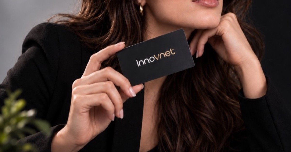 Phone scanning a QR code on an Innovnet card